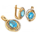 Złote kolczyki i zawieszka z niebieskim oczkiem