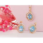 Złote kolczyki i zawieszka z niebieskim oczkiem