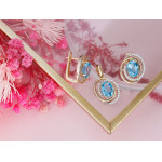 Złote kolczyki i zawieszka z niebieskim oczkiem