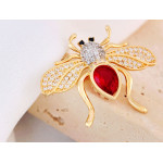 Złota broszka pszczoła z czerwonym kamieniem